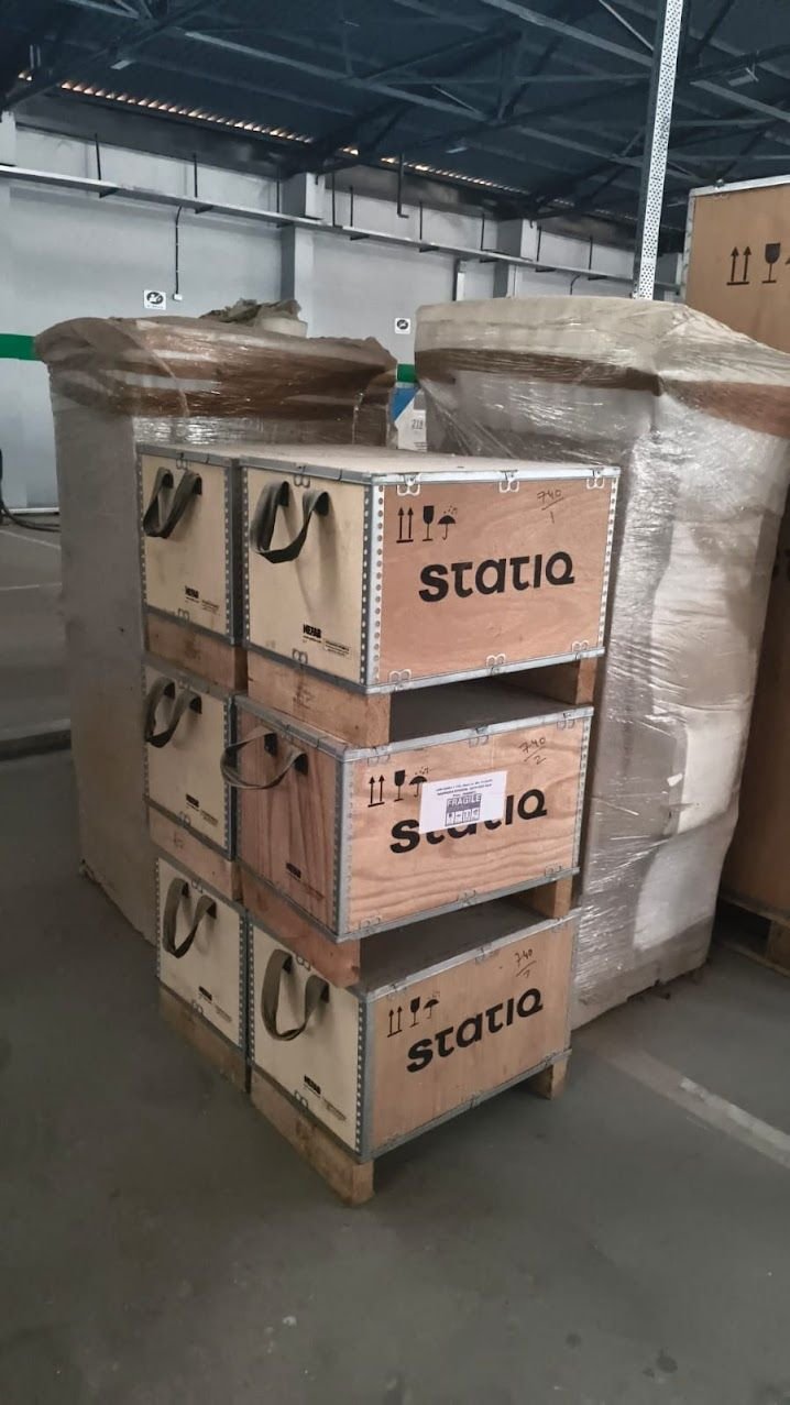 Wooden crates for corporate equipment relocation, stacked and labelled fragile