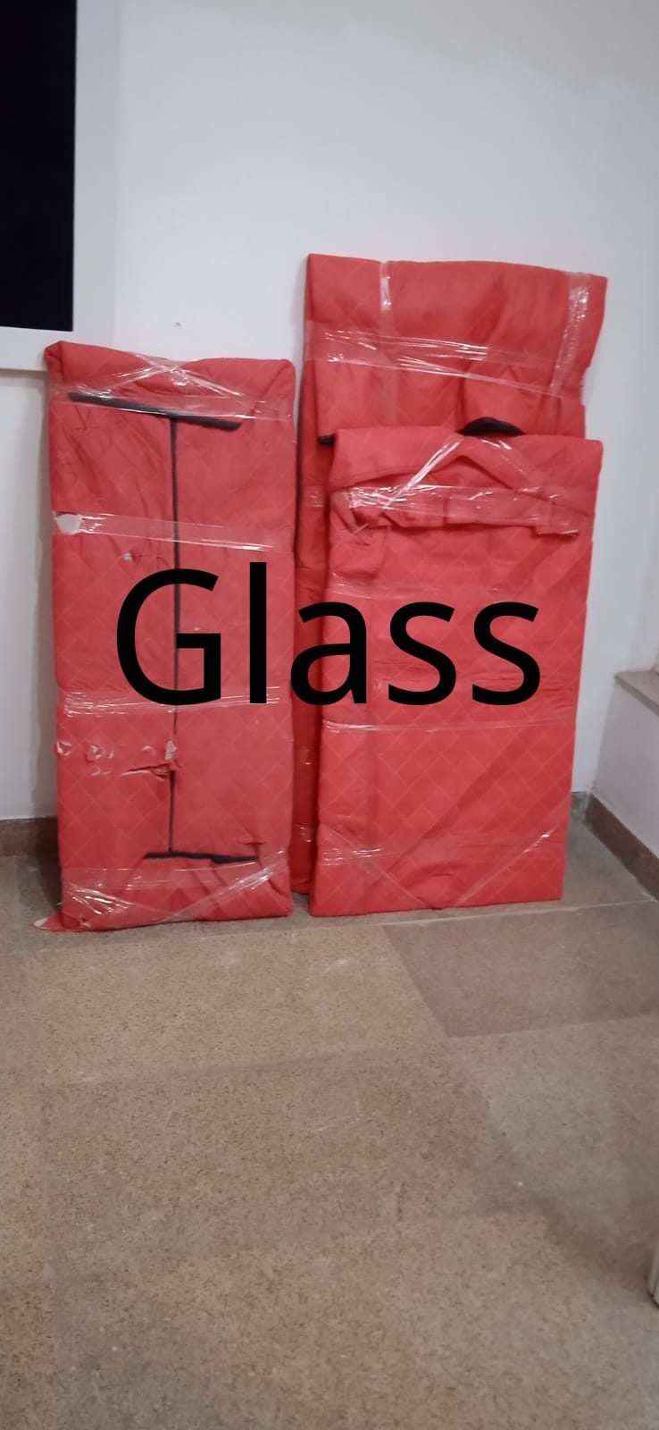 Padded covers labelled for fragile glass items