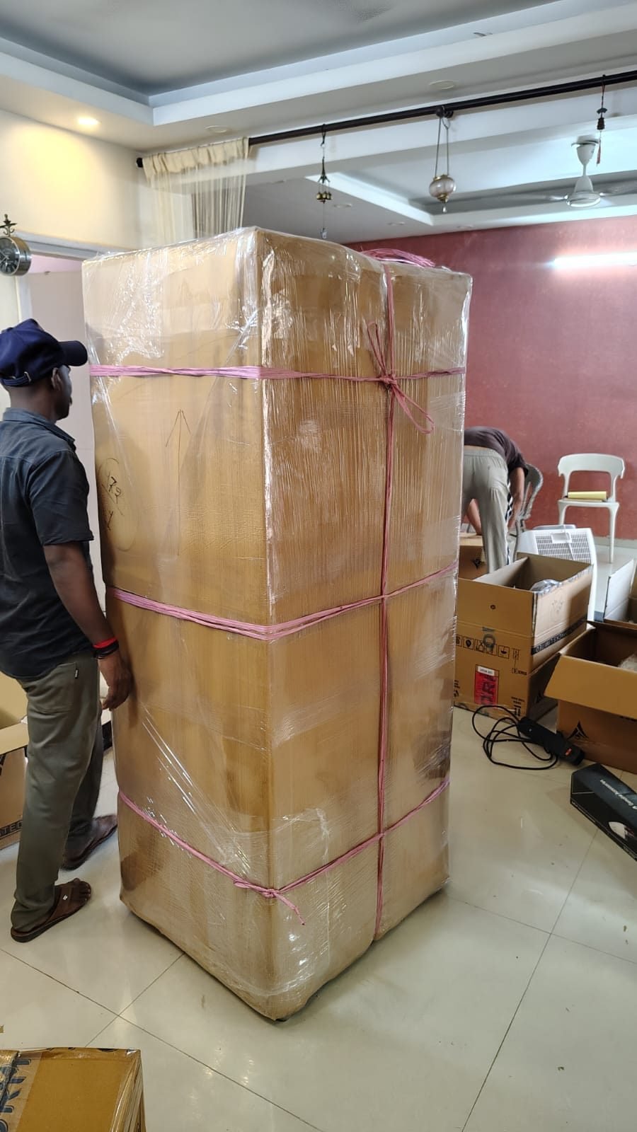 Wrapped wardrobe being moved out of a home
