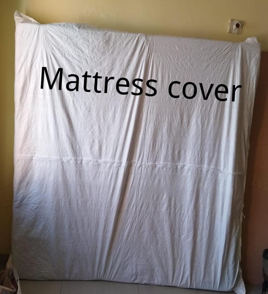 Mattress wrapped in a protective cover for transit