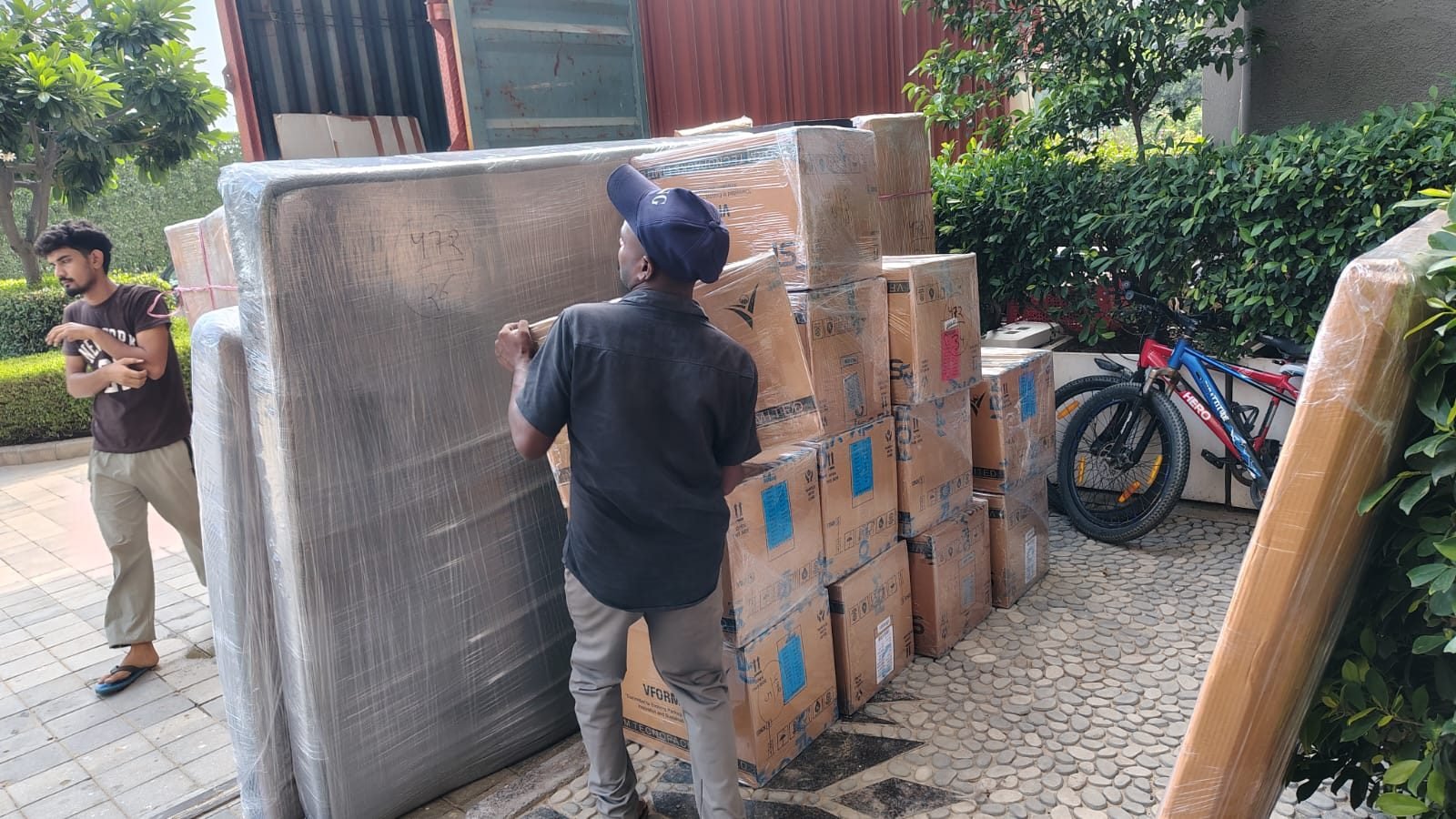 Movers handling a large wrapped item